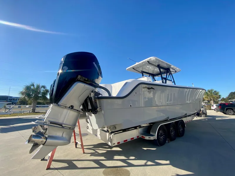 Slide: The Image of 2024 Invincible 35 Catamaran boat on a trailer with dual outboard engines. - 4