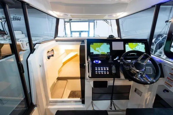 Slide: The Image of 2024 Quarken 27 Cabin interior with navigation system and cozy sleeping area. - 12