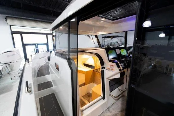Slide: The Image of 2024 Quarken 27 Cabin interior view with modern navigation equipment. - 13