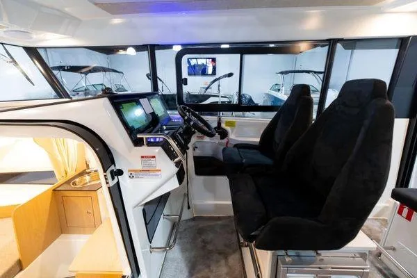 Slide: The Image of Interior of 2024 Quarken 27 Cabin boat with modern cockpit and seating. - 14