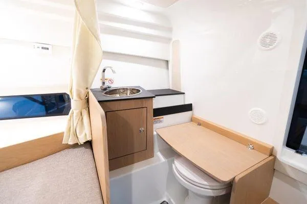 Slide: The Image of 2024 Quarken 27 Cabin interior with compact kitchenette and toilet. - 20
