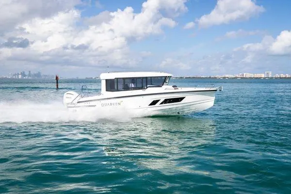 Slide: The Image of 2024 Quarken 27 Cabin boat cruising on open water. - 4