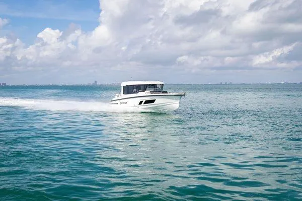 Slide: The Image of 2024 Quarken 27 Cabin boat cruising on open water under a partly cloudy sky. - 5