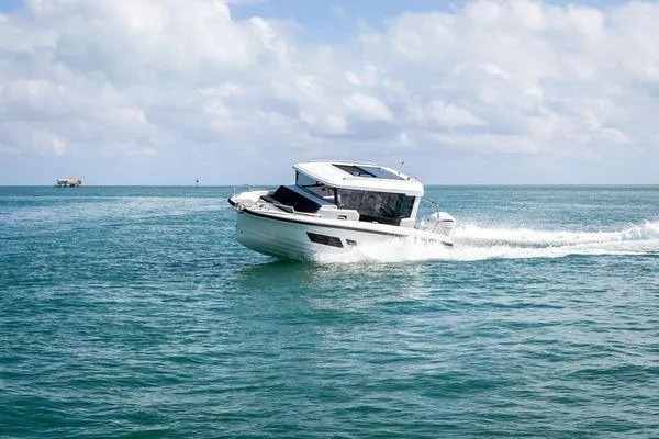 Slide: The Image of 2024 Quarken 27 Cabin boat cruising on open water. - 7