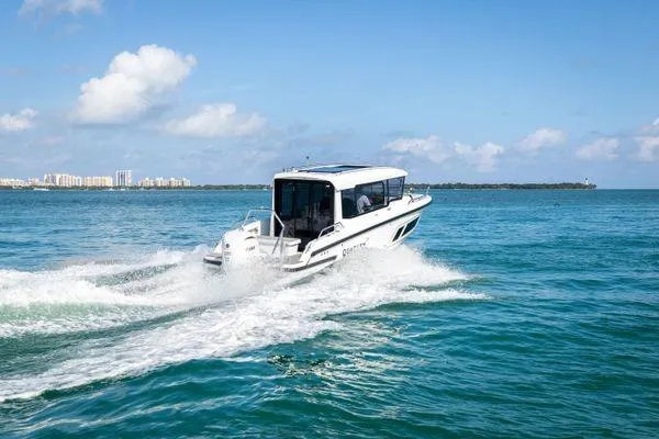 Slide: The Image of 2024 Quarken 27 Cabin boat cruising on clear blue water. - 8