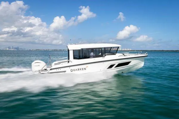 Slide: The Image of 2024 Quarken 27 Cabin boat cruising on clear blue water under a sunny sky. - 9