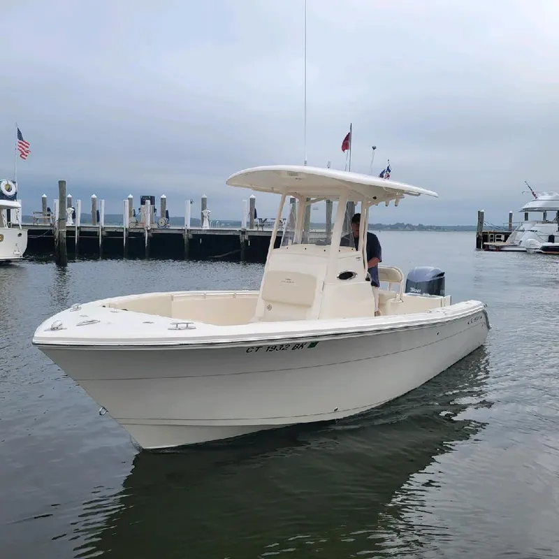 Slide: The Image of 2019 Cobia 240 CC boat docked in a marina. - 1