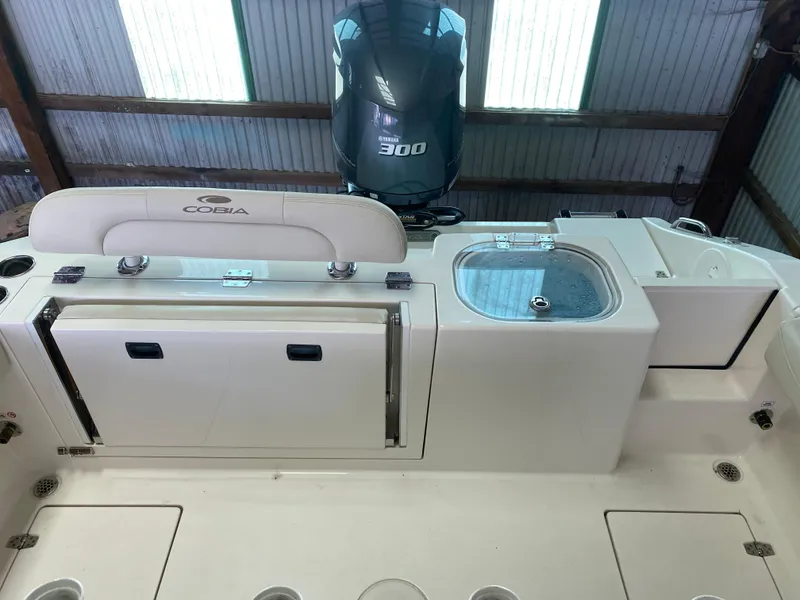Slide: The Image of 2019 Cobia 240 CC boat with Yamaha 300 engine in a storage facility. - 13