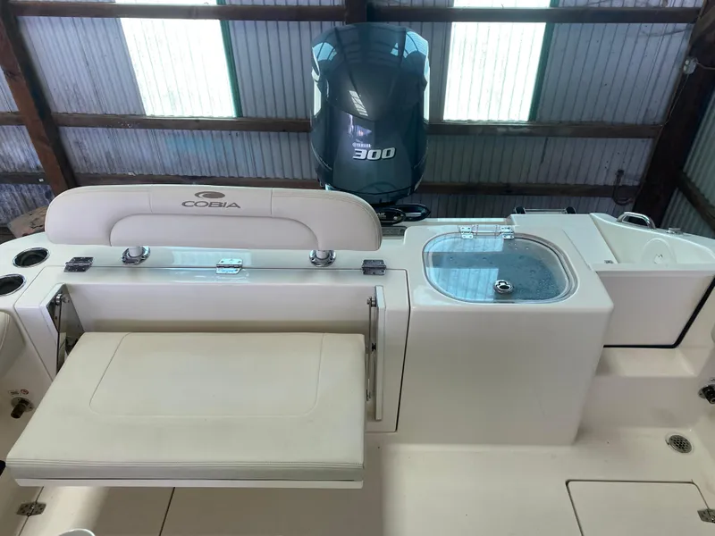 Slide: The Image of 2019 Cobia 240 CC boat with Yamaha 300 engine in a storage facility. - 14