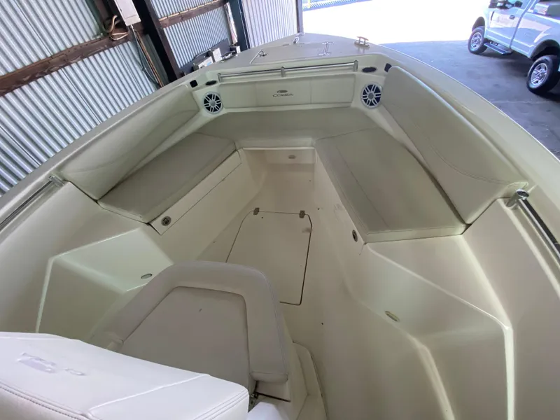 Slide: The Image of 2019 Cobia 240 CC boat interior with cushioned seating and storage compartments. - 16