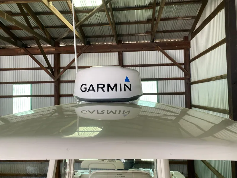 Slide: The Image of 2019 Cobia 240 CC with Garmin radar in a boat shed. - 17