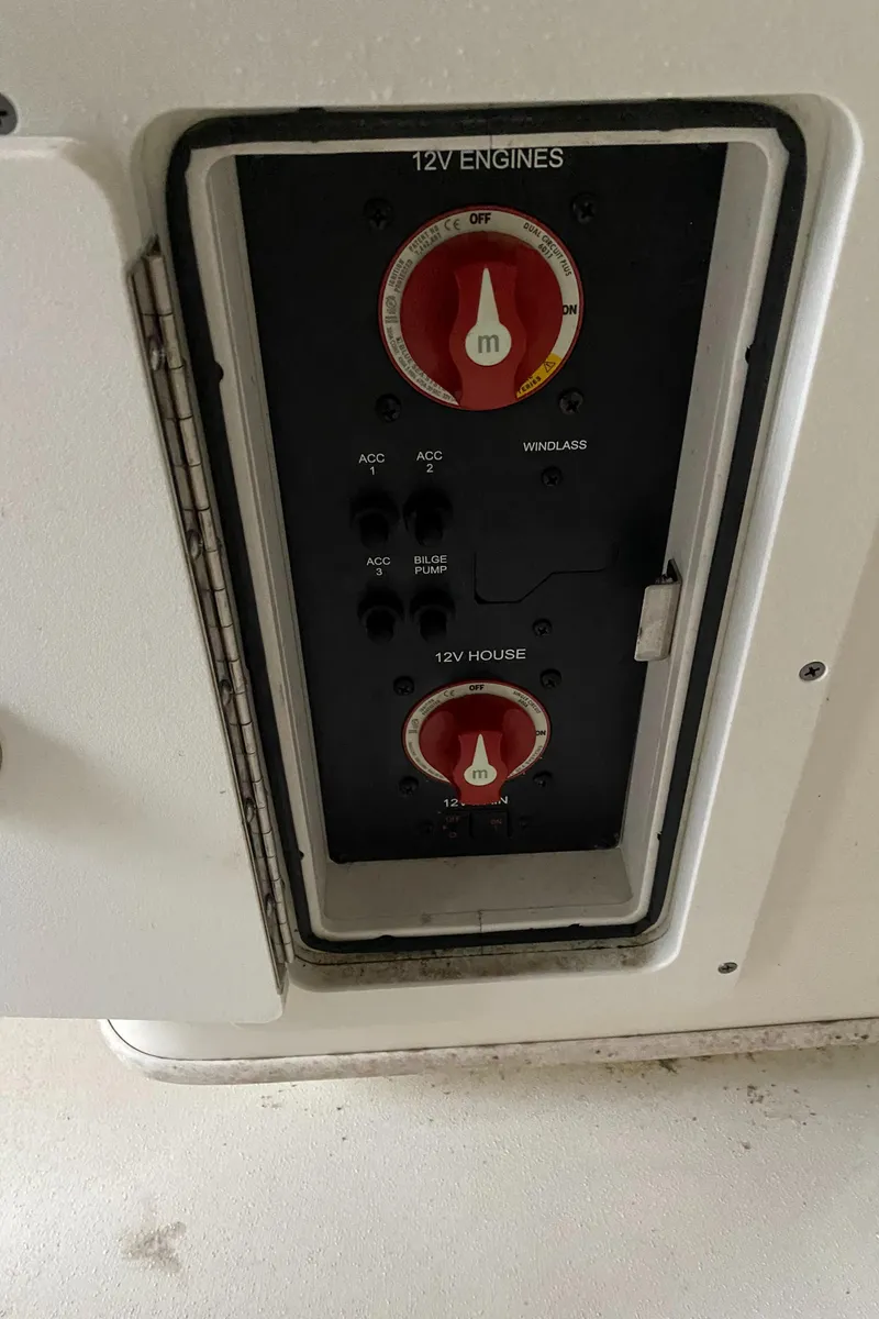 Slide: The Image of 2019 Cobia 240 CC boat electrical panel with 12V engine and house switches. - 21