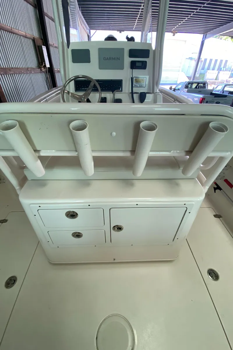 Slide: The Image of 2019 Cobia 240 CC center console with rod holders and storage compartments. - 6