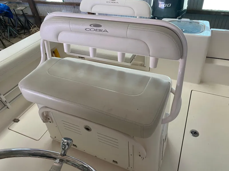 Slide: The Image of 2019 Cobia 240 CC boat seating and helm station. - 7