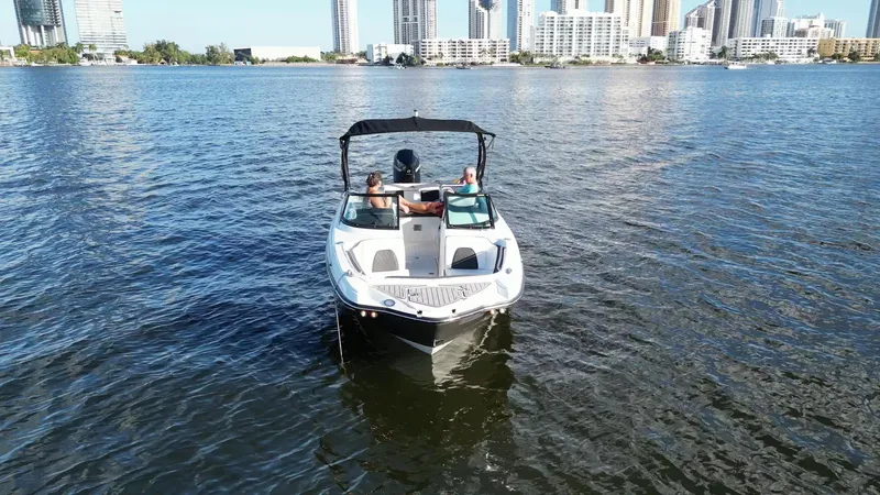 Slide: The Image of 2021 Monterey M-45 boat cruising on a city waterfront with skyscrapers in the background. - 10