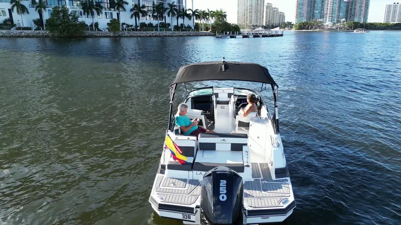 Slide: The Image of 2021 Monterey M-45 boat cruising on a scenic waterway with two passengers. - 11