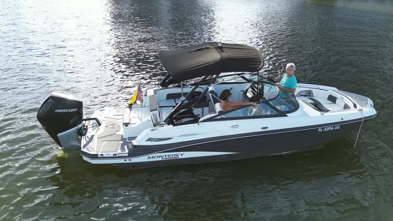 Slide: The Image of 2021 Monterey M-45 boat on water, featuring sleek design and Mercury outboard engine. - 15