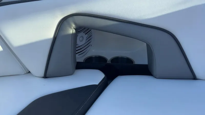 Slide: The Image of 2021 Monterey M-45 boat interior with speaker and cup holders, featuring sleek white and gray design. - 22