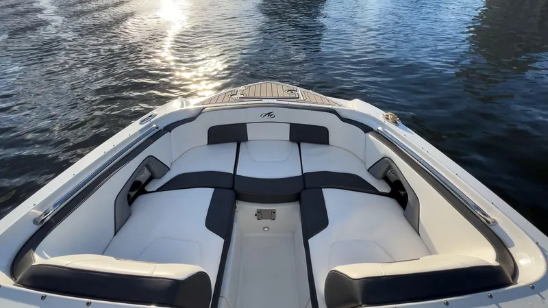 Slide: The Image of 2021 Monterey M-45 boat interior with cushioned seating on calm water. - 23