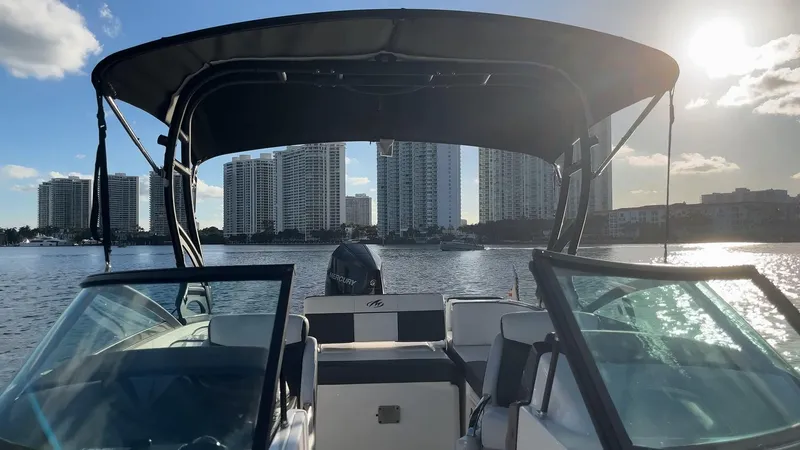 Slide: The Image of 2021 Monterey M-45 boat on water with city skyline in background, under sunny sky. - 24