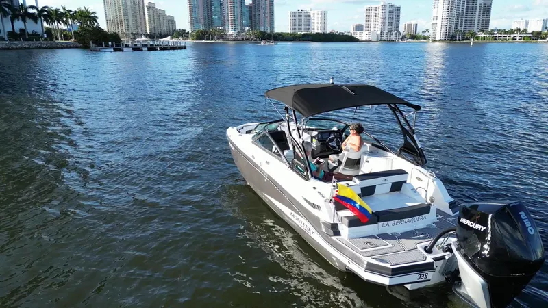 Slide: The Image of 2021 Monterey M-45 boat cruising on a scenic urban waterway with city skyline. - 3