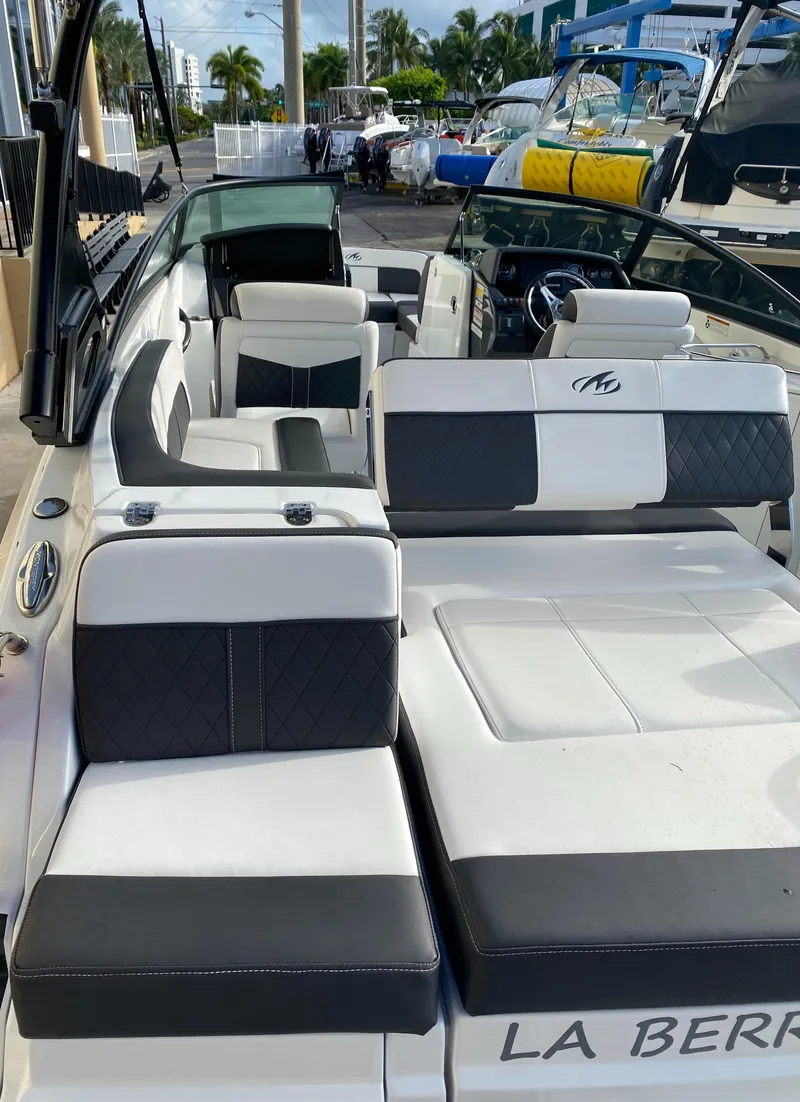 Slide: The Image of 2021 Monterey M-45 boat with sleek black and white seating, docked at a marina. - 43