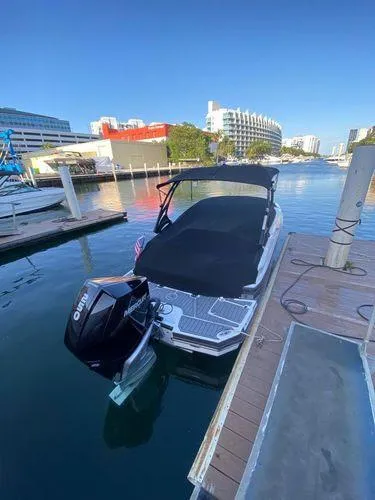 Slide: The Image of 2021 Monterey M-45 boat docked in a marina with buildings in the background. - 46
