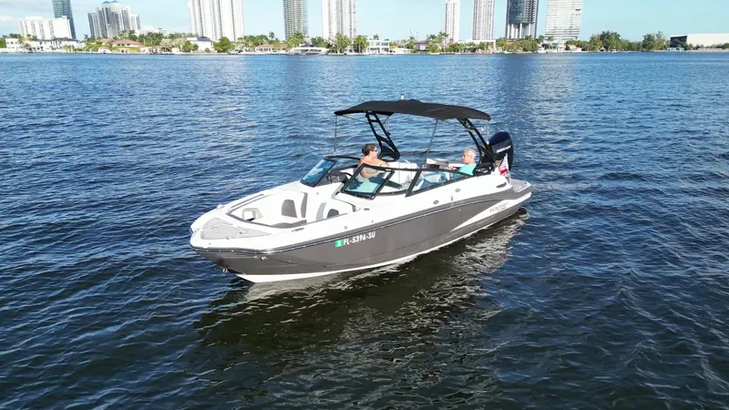 Slide: The Image of 2021 Monterey M-45 boat cruising on a sunny day with city skyline in background. - 7