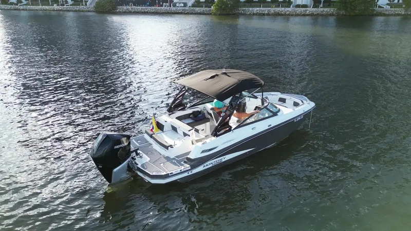 Slide: The Image of 2021 Monterey M-45 boat on calm water, featuring a sleek design and canopy. - 8