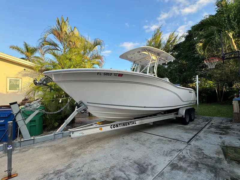 Slide: The Image of 2022 Sea Fox 248 Commander boat on a Continental trailer in a driveway. - 0