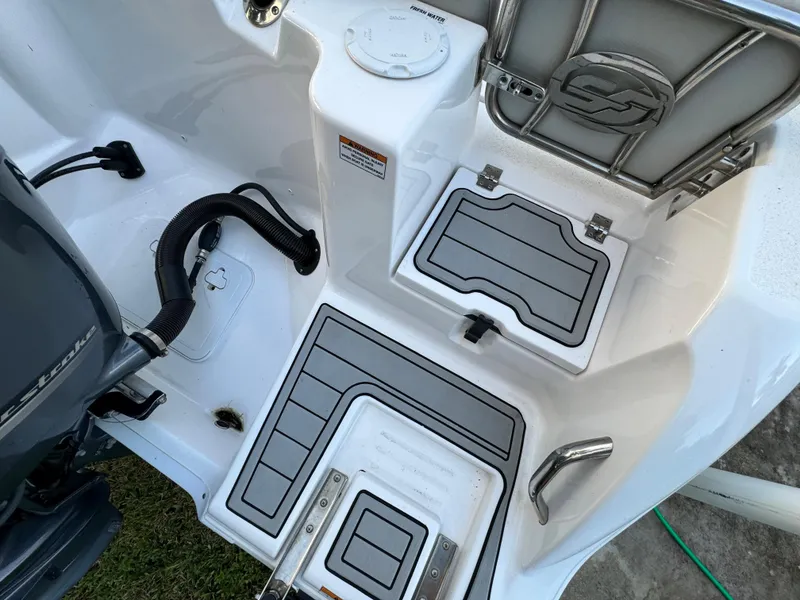 Slide: The Image of 2022 Sea Fox 248 Commander boat deck with storage compartments and engine. - 13