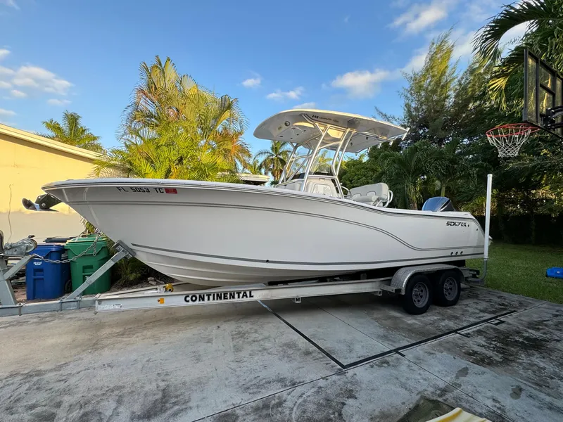 Slide: The Image of 2022 Sea Fox 248 Commander boat on a Continental trailer in a driveway. - 2