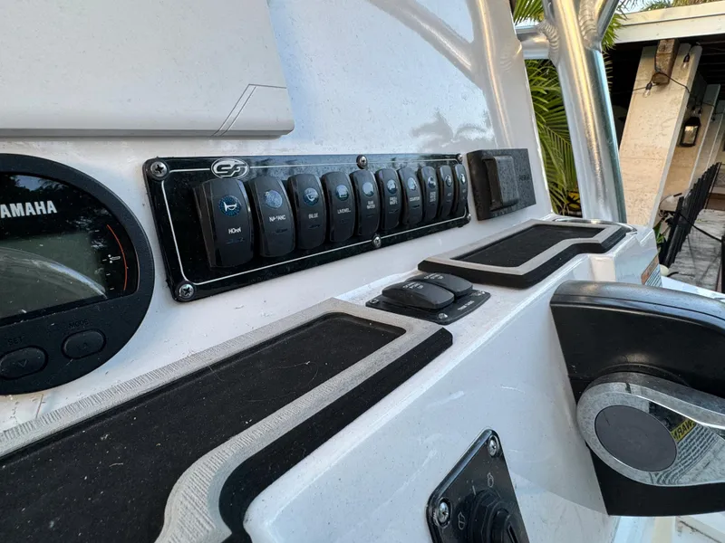 Slide: The Image of 2022 Sea Fox 248 Commander dashboard with Yamaha gauge and control switches. - 34