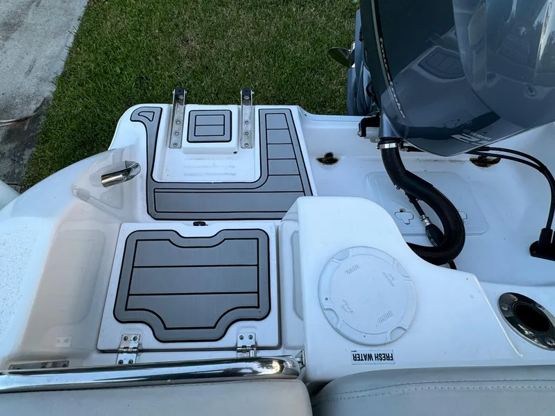 Slide: The Image of 2022 Sea Fox 248 Commander boat deck with storage compartments and engine. - 37