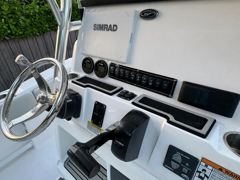 Slide: The Image of 2022 Sea Fox 248 Commander boat dashboard with Simrad electronics and steering wheel. - 38