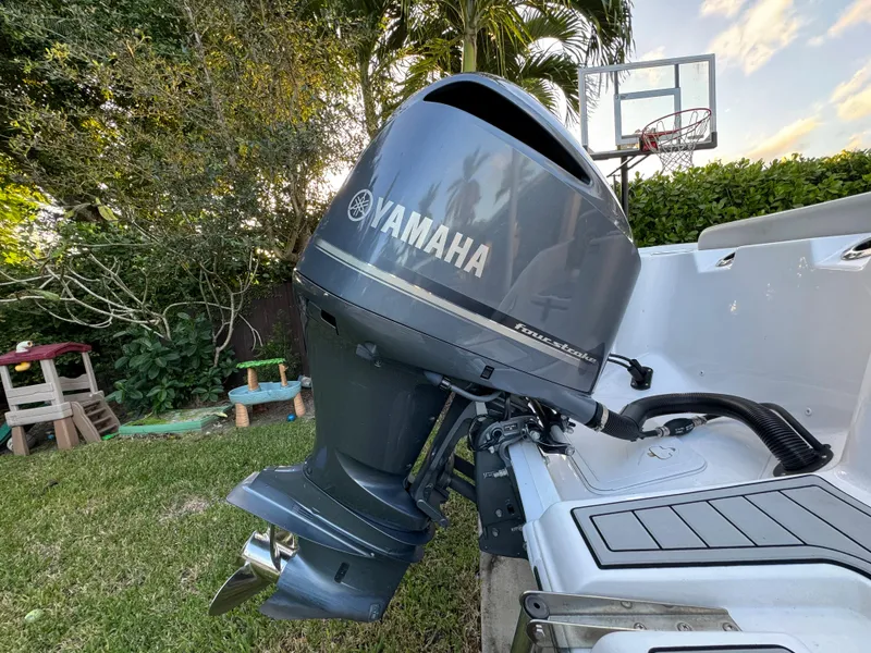 Slide: The Image of Yamaha outboard motor on a 2022 Sea Fox 248 Commander boat in a backyard. - 9