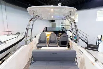 Slide: The Image of 2024 Quarken 27 T-Top V2 boat interior with seating and helm station. - 10