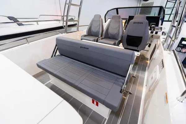 Slide: The Image of 2024 Quarken 27 T-Top V2 boat interior with grey seating and modern design. - 12