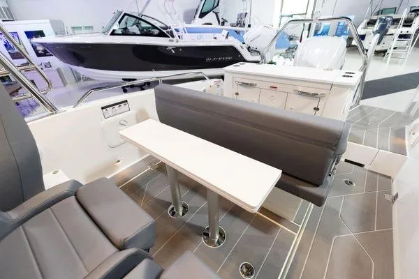 Slide: The Image of Interior of 2024 Quarken 27 T-Top V2 boat with seating and table. - 15