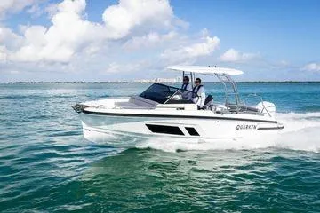 Slide: The Image of 2024 Quarken 27 T-Top V2 boat cruising on clear blue water. - 2