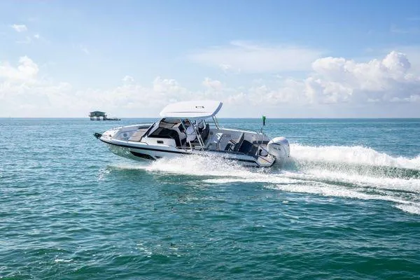 Slide: The Image of 2024 Quarken 27 T-Top V2 boat cruising on open water. - 8