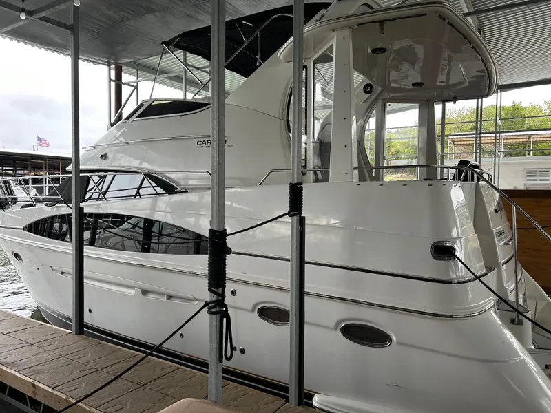 Slide: The Image of 2000 Carver 396 yacht docked under a covered marina. - 10