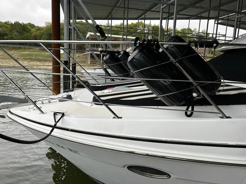 Slide: The Image of 2000 Carver 396 yacht docked, featuring sleek design and protective fenders. - 11