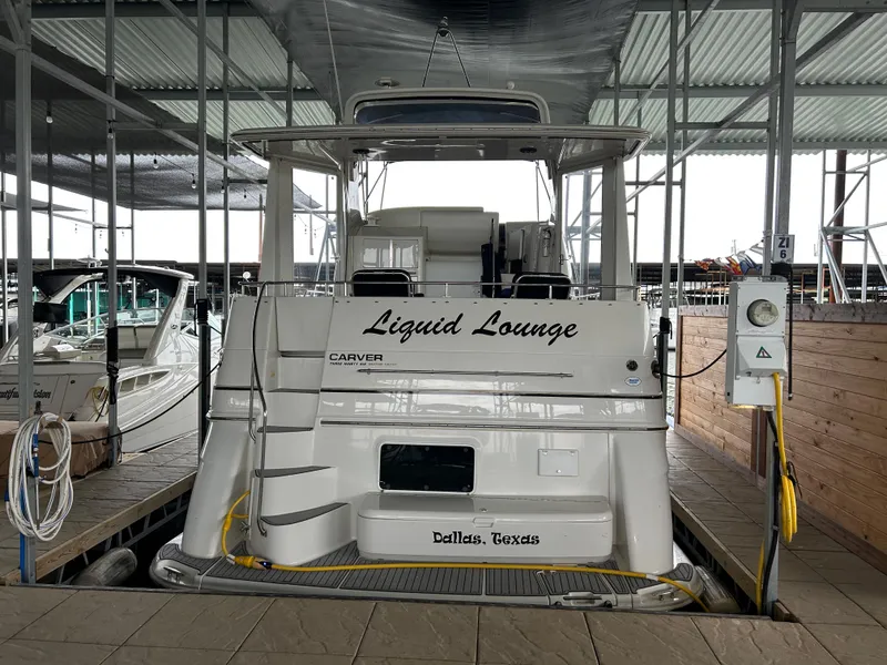 Slide: The Image of 2000 Carver 396 yacht named "Liquid Lounge" docked in Dallas, Texas marina. - 12
