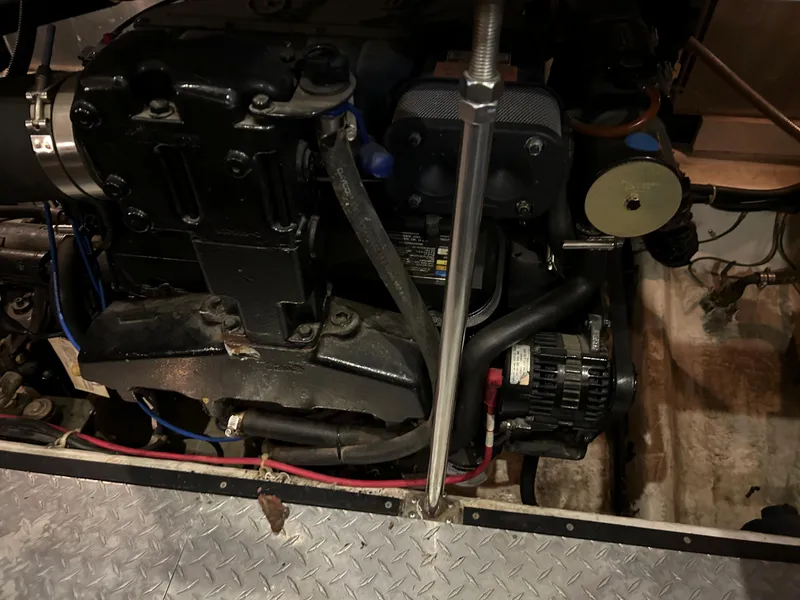 Slide: The Image of Engine compartment of a 2000 Carver 396 boat, featuring mechanical components and wiring. - 15