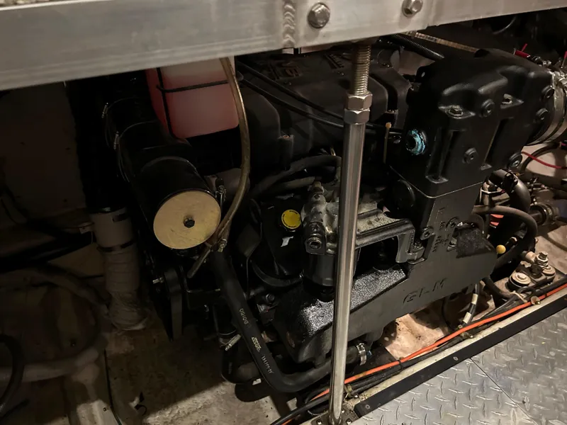 Slide: The Image of Engine compartment of a 2000 Carver 396 boat, showcasing mechanical components and wiring. - 16