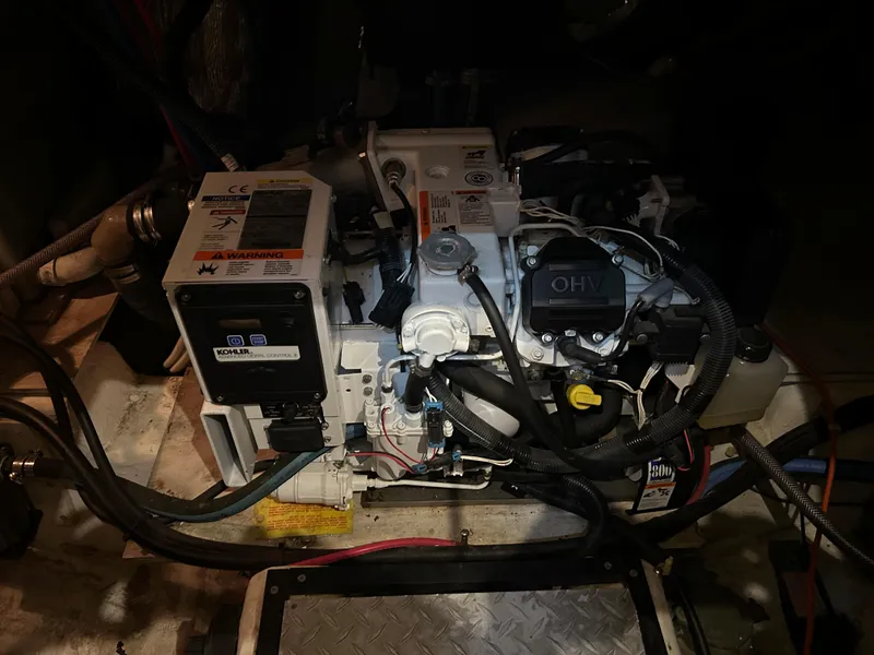 Slide: The Image of Engine compartment of a 2000 Carver 396 boat, featuring detailed mechanical components. - 17