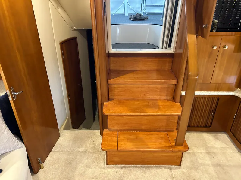 Slide: The Image of Interior view of 2000 Carver 396 yacht, featuring wooden stairs and cabinetry. - 23