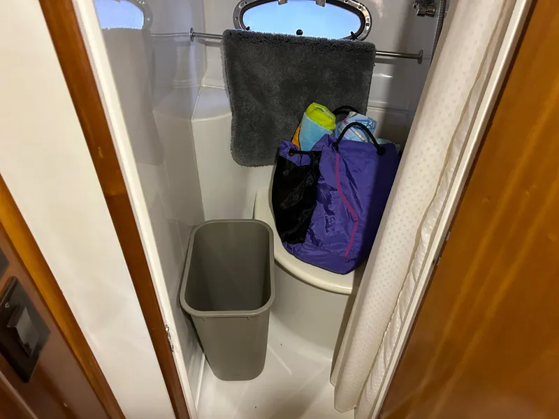 Slide: The Image of Small bathroom in 2000 Carver 396 yacht with bags and towel. - 31