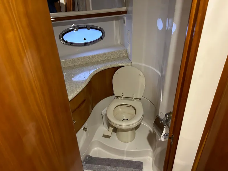 Slide: The Image of Bathroom interior of 2000 Carver 396 yacht with toilet and porthole window. - 33